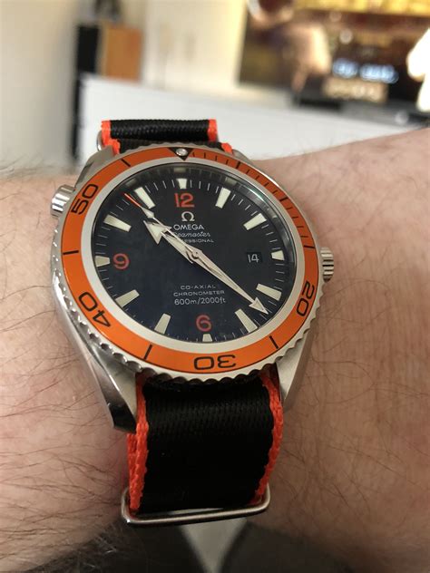 omega planet ocean orange strap.